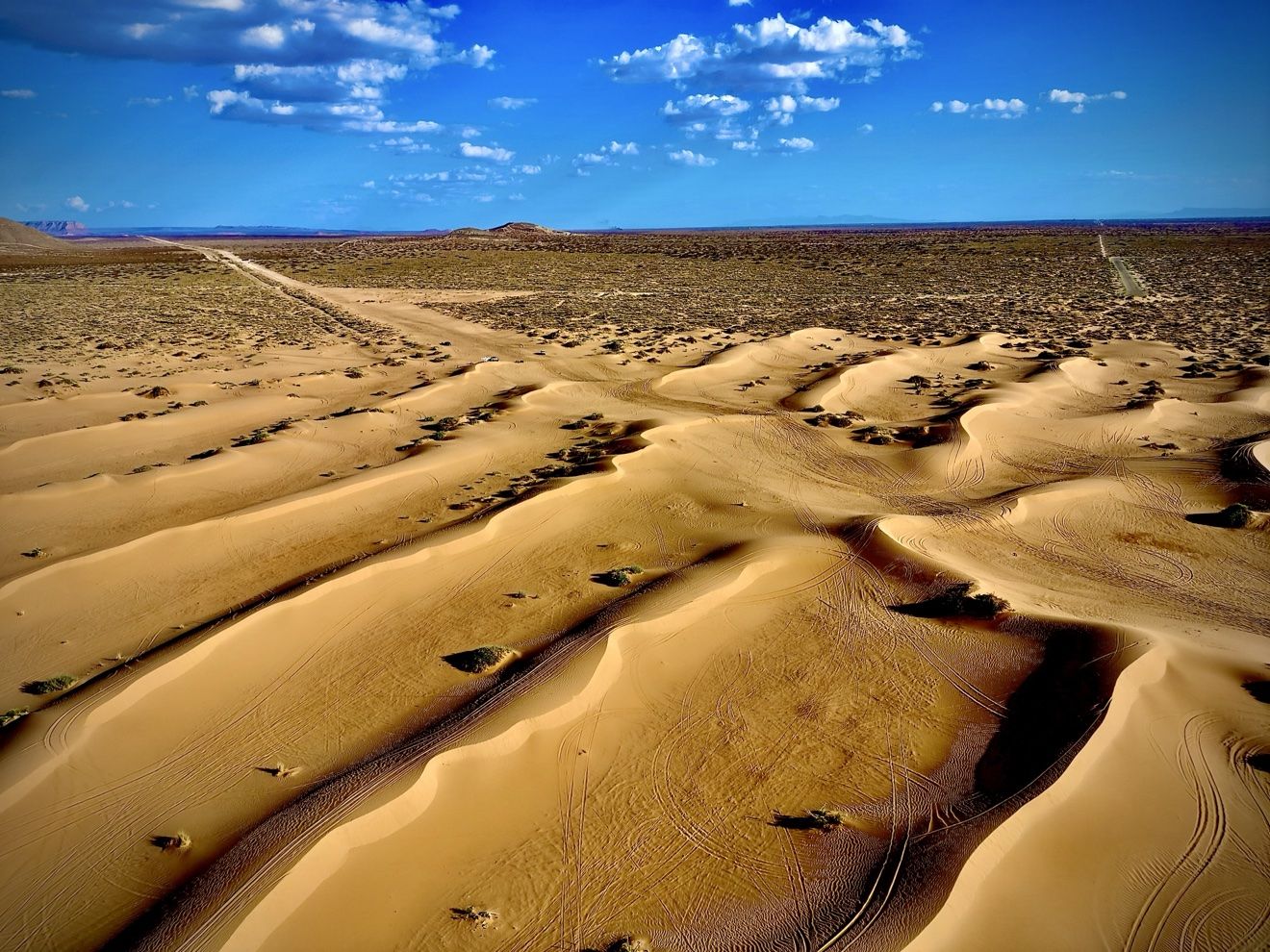 Aerial view of layered Red Sands dune ridges