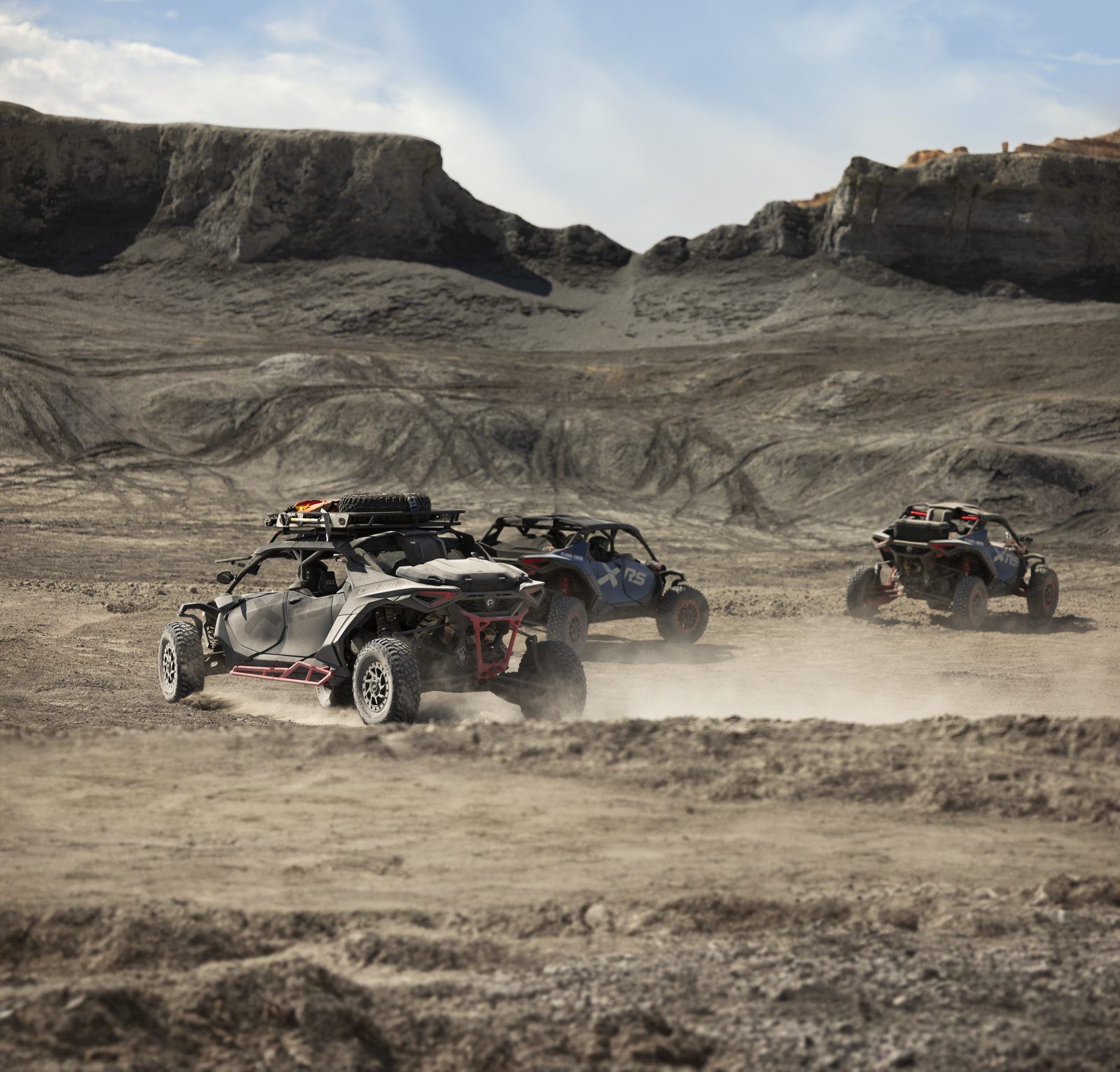 Can-Am UTV group riding through rugged desert terrain