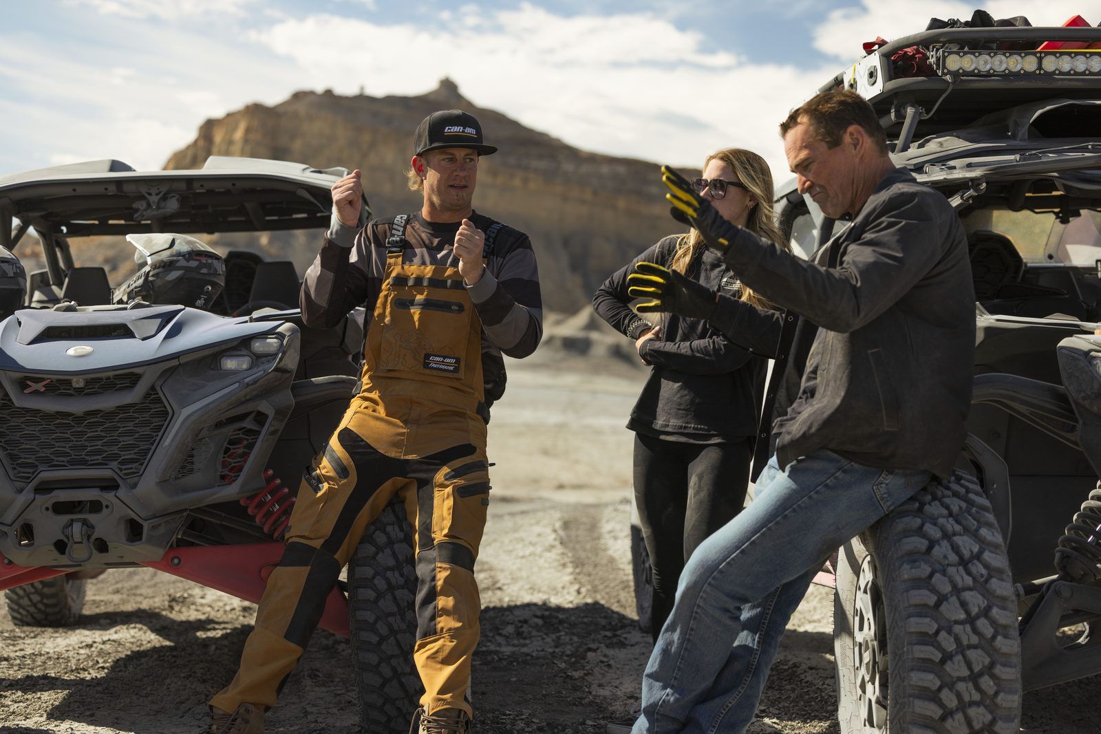 Guide explaining the ride to a group beside Can-Am UTVs